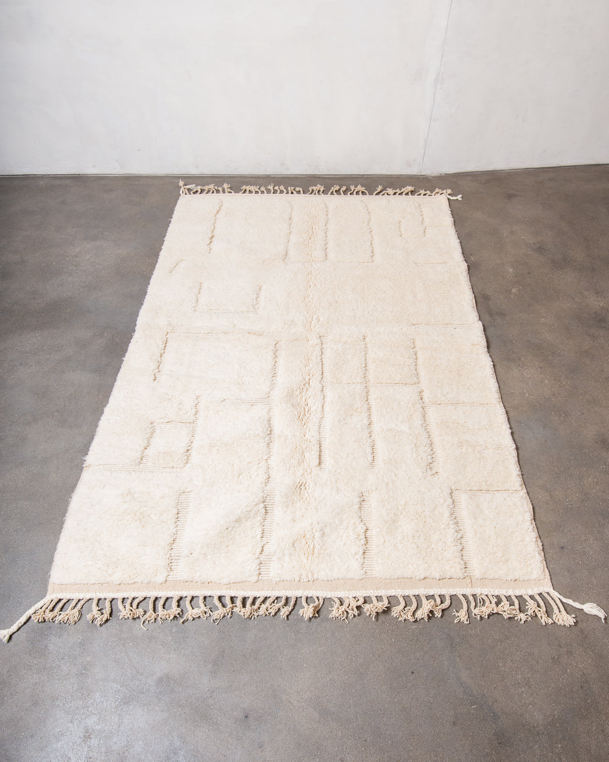 Modern, designer, handcrafted Berber rug from Morocco. Beniourain carpet with minimalist design, natural wool pile and a fluffy texture.